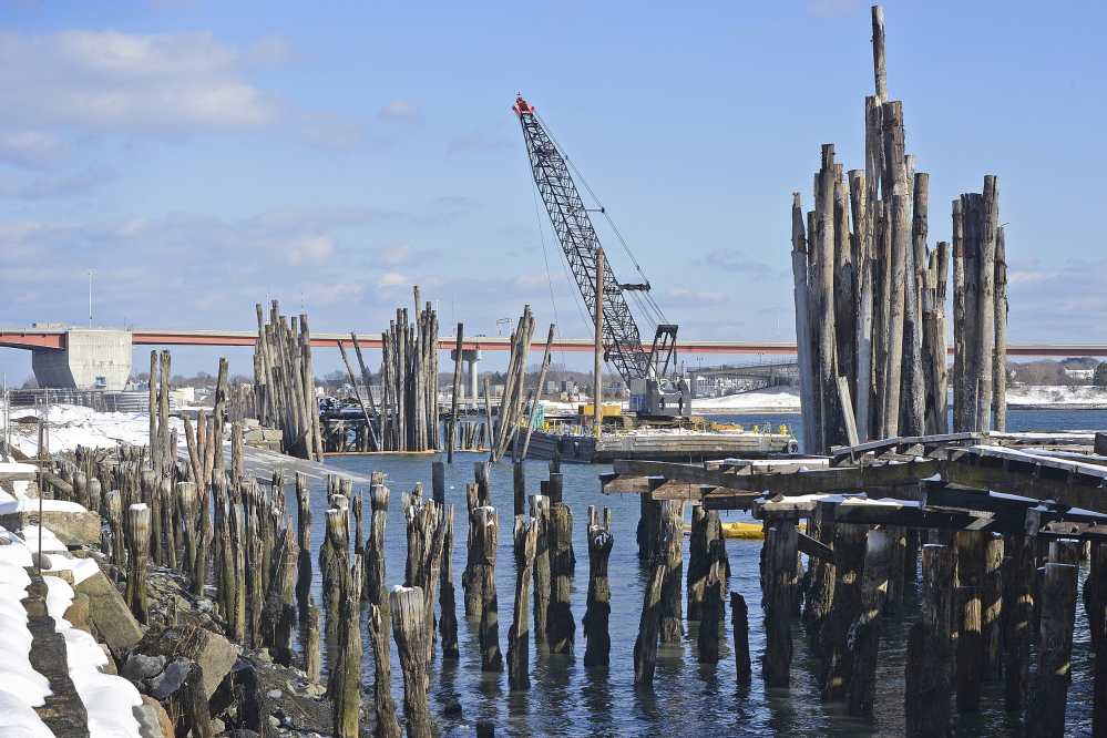 Pilings stand in the water off land in Portland owned by Phineas Sprague Jr. State officials plan to use the power of eminent domain next month to take most of his 22 acres, and Sprague plans to use his profit from the sale to buy nearby land for the boatyard and offices he’s building.