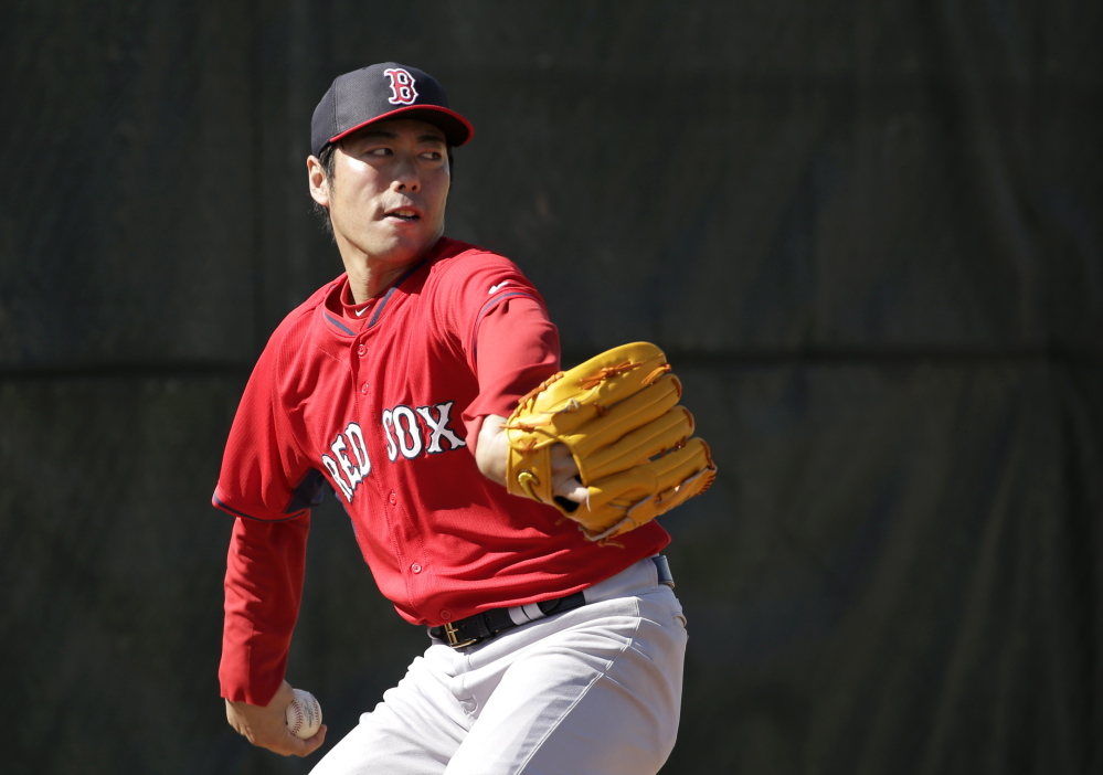 Boston Red Sox relief pitcher Koji Uehara winds up for a throw in the bullpen during spring training baseball practice on Feb. 20 in Fort Myers, Fla.
