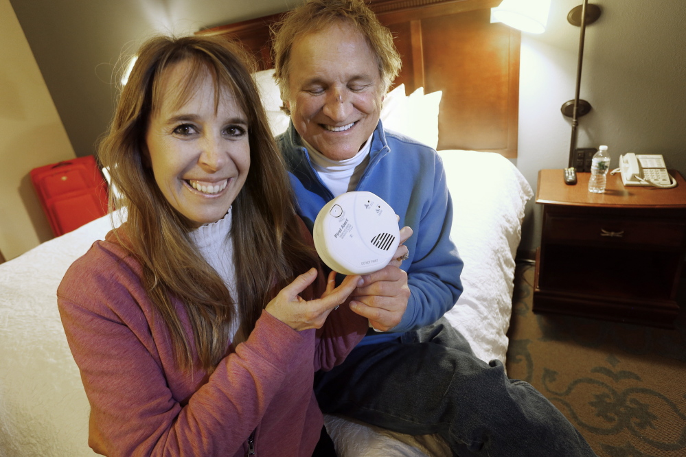 John Yates and Lori Blackwell of Southbury, Conn., in their hotel room in Wells on Wednesday, show a plug-in carbon monoxide detector they purchased Sunday after becoming ill from the gas at an Ogunquit resort.