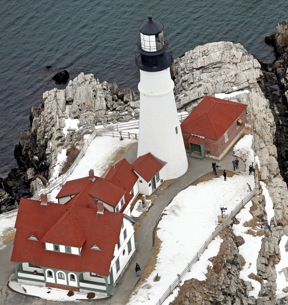 Tourists visit Portland Head Light in Cape Elizabeth on Tuesday. The town is looking at a project that would enhance the surrounding landscape.
