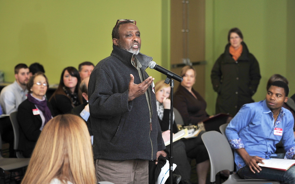 Mohamud Barre, executive director of Maine Access Immigrant Network, asks questions Thursday as representatives of the hotel industry and refugee assistance groups and city officials meet at the Portland Public Library to discuss ways to improve job opportunities for immigrants in Portland’s growing hospitality sector.