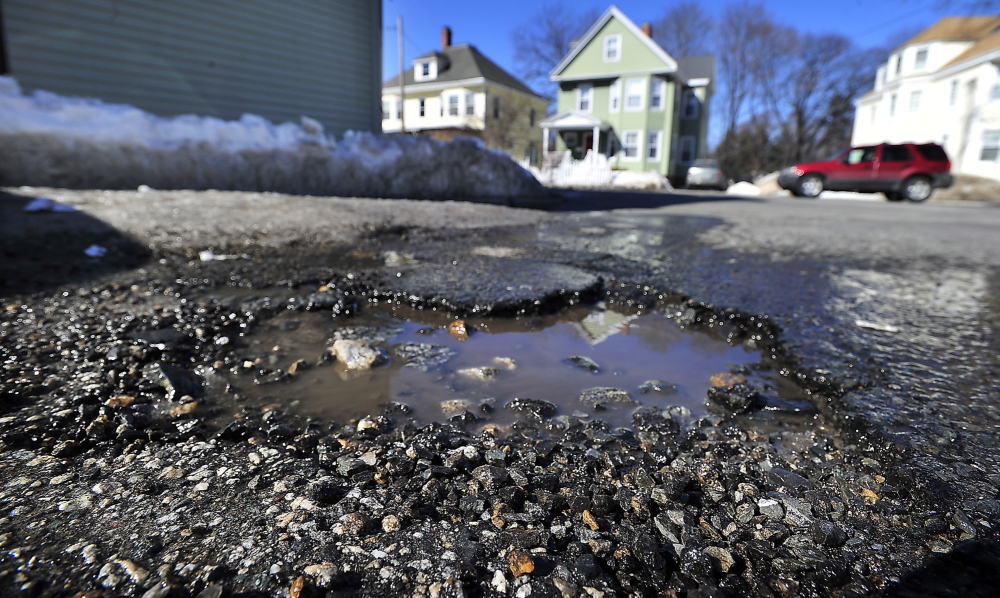 Potholes like this one on a side street off Woodford Street in Portland appear to be more common and worse than usual.