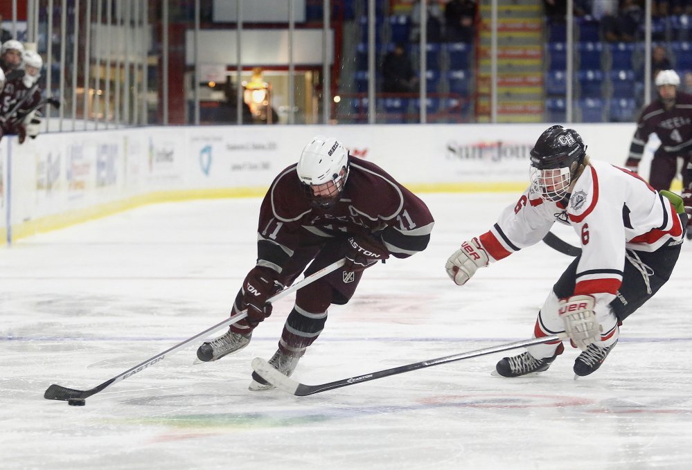 Aidan Black of Greely skates past Parker Lawson of Camden Hills, Friday, Feb. 28, 2014, during the Class B West semifinal game at the Colisee in Lewiston.