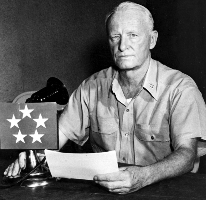 U.S. Fleet Adm. Chester W. Nimitz poses while reading the communique from his advance headquarters in Guam on April 1, 1945, during World War II, when he revealed to the world the news of the U.S. invasion of Okinawa, 325 miles from Tokyo.