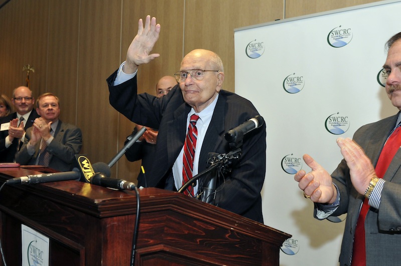 U.S. Rep. John Dingell, center, is welcomed as he arrives at the Southern Wayne County Regional Chamber Legislative forum held at the Crystal Gardens in Southgate, Mich. on Monday. Dingell, the longest-serving member of Congress in American history and a champion of Detroit's auto industry, has announced his retirement.