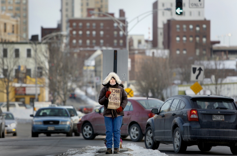 Laurel Merchant panhandles in February in the median at Preble Street Extension and Marginal Way in Portland. The city has received a 30-day extension to decide whether or not to appeal a federal court ruling that struck down a ban on loitering and panhandling in street medians.
