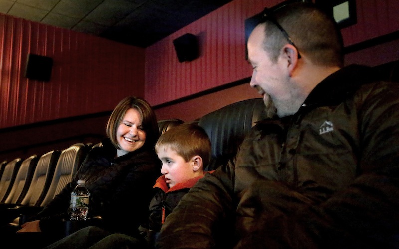 Erin and Aaron Geyer of Parsonsfield and their son, Ethan, 6, watch a sensory friendly showing of "The Lego Movie" for kids with autism at Cinemagic Grand in Clarks Pond in South Portland in February. The government's estimate of autism has moved up again to 1 in 68 U.S. children, a 30 percent increase in two years.
