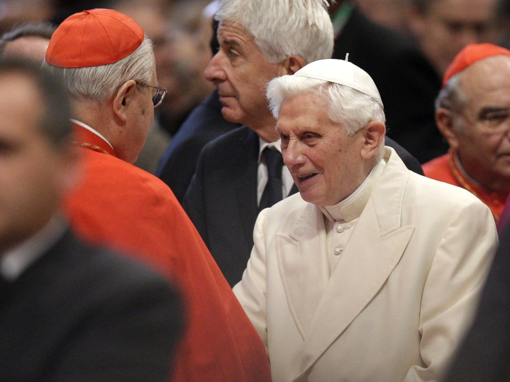 Pope Emeritus Benedict XVI is greeted by Cardinal Angelo Sodano, left, as he arrives for a consistory inside St. Peter’s Basilica at the Vatican last Saturday.