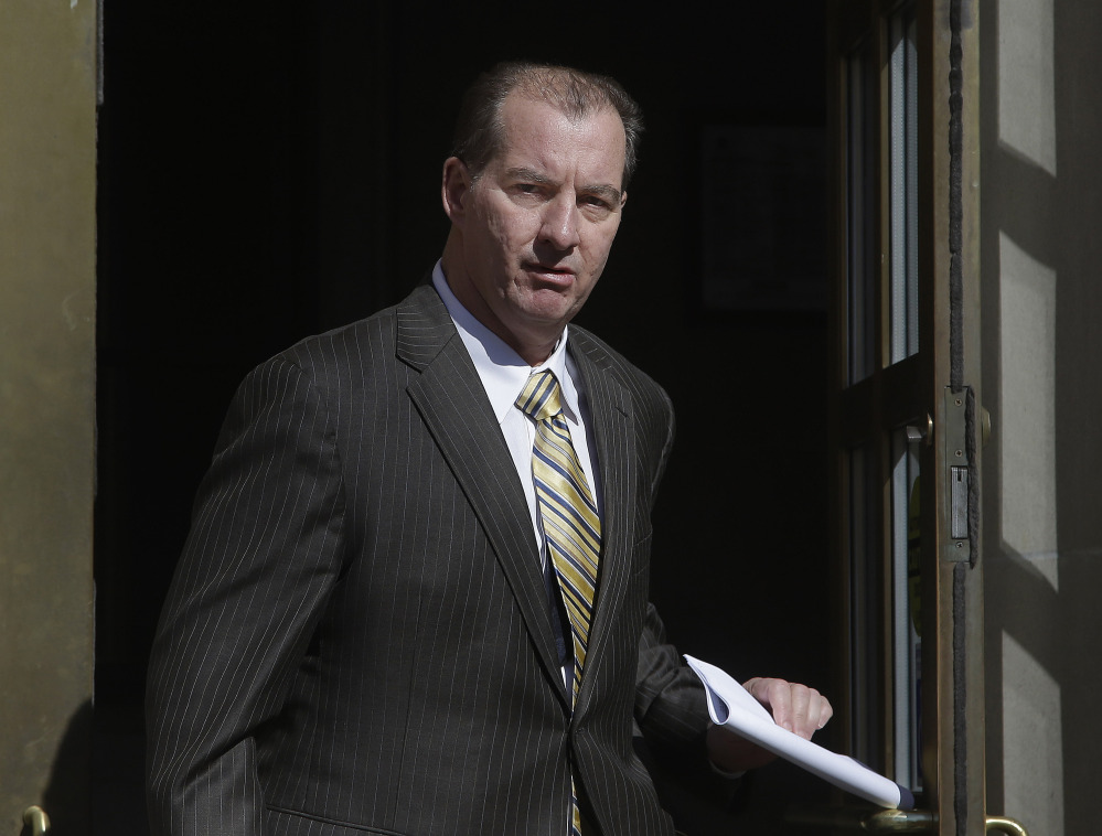Former Central Falls, RI., Mayor Charles Moreau walks out of the federal courthouse in Providence, R.I., Friday after serving just under one year of a two-year sentence.