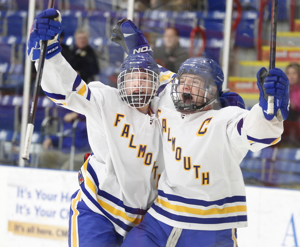 Christopher Camelio, left, of Falmouth celebrates with Andrew Clement on Saturday after Clement scored the winning goal against Noble/Wells late in the third period of a Western Class A semifinal at the Colisee in Lewiston. The Yachtsmen will face Scarborough in the regional final on Tuesday.