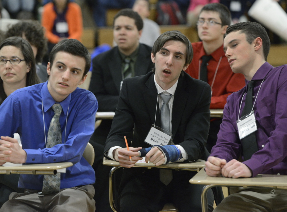 Scarborough’s Mason Roach, Alexander Clary and Andrew Morrissey consider an answer during the Maine Academic Decathlon at Deering High School on Saturday.