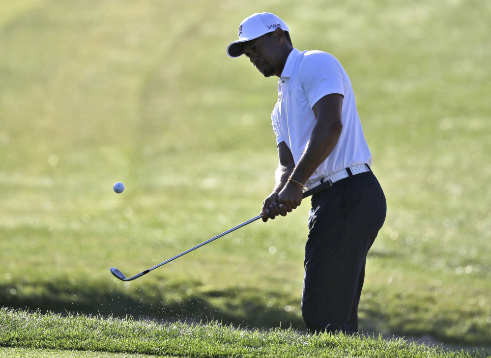 Tiger Woods hits from a bunker onto the second hole during the third round of the Honda Classic golf tournament on Saturday in Palm Beach Gardens, Fla. Woods shot a 65.