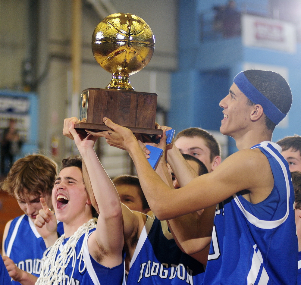Hodgdon players hold the Gold Ball aloft after they beat Valley 54-49 to win the Class D boys’ basketball state championship Saturday at the Augusta Civic Center.