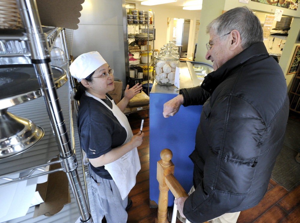 Independent Eliot Cutler talks with Irene Lim, owner of Fernleaf Bakery in Saco, on Wednesday. Cutler has been campaigning as though the election were weeks away, a political necessity for lack of a ready-made platform.