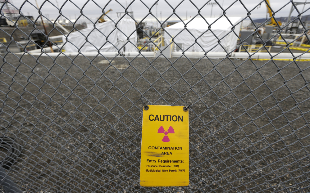 A sign warns of possible radiation at a tank farm at the Hanford Nuclear Reservation near Richland, Wash. Documents obtained by the Associated Press show that there are significant construction flaws in some newer, double-walled storage tanks at the nuclear waste complex.