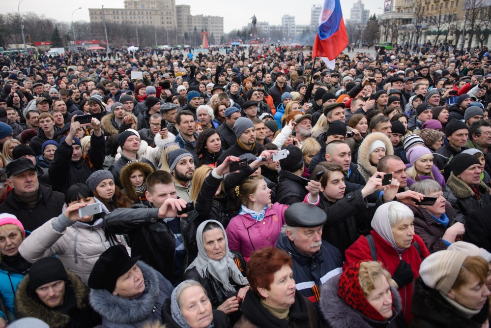 Pro-Russian demonstrators, holding a Russian flag, gather for a rally at the local administration building in the northeastern city of Kharkiv, Ukraine, Saturday.