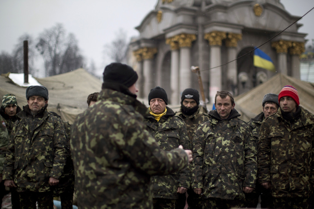 Ukrainian recruits receive instructions from a commander in a recruitment self defense quarter at Kiev’s Independence Square on Monday. The U.S. and its allies are weighing sanctions on Moscow and whether to bolster defenses in Europe in response to Russia’s military advances on Ukraine.