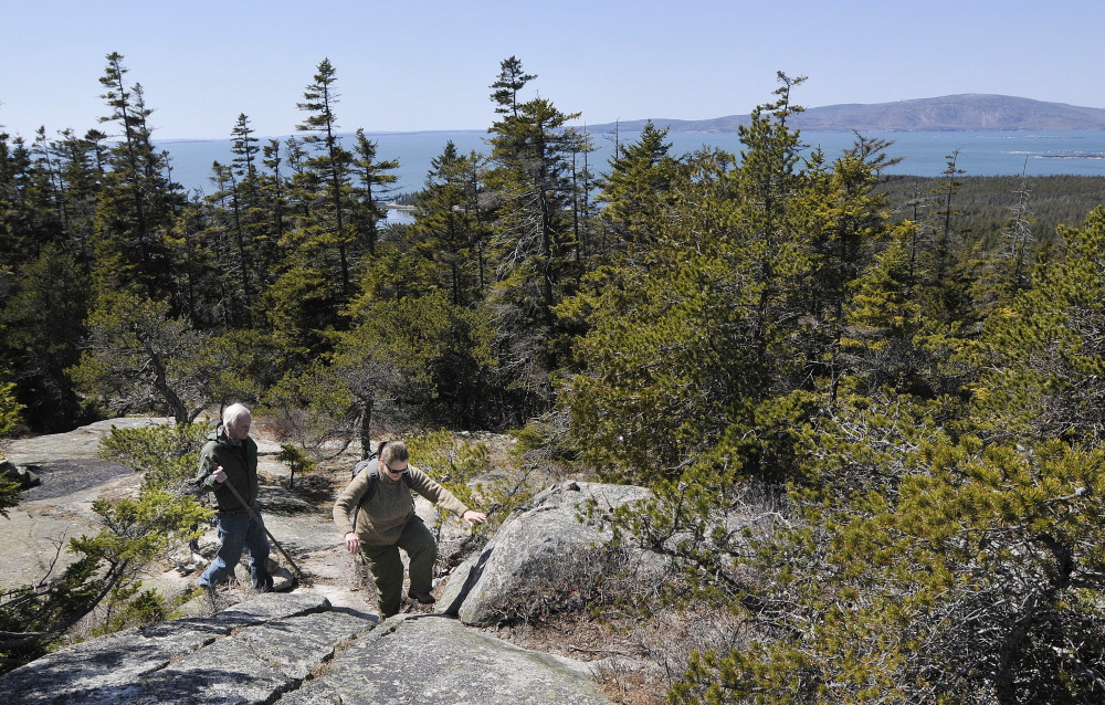 Hikers explore Schoodic Head in Acadia National Park in 2011. In the background are the Atlantic Ocean and Cadillac Mountain. Fewer than 95,000 people visited Acadia in October 2013.