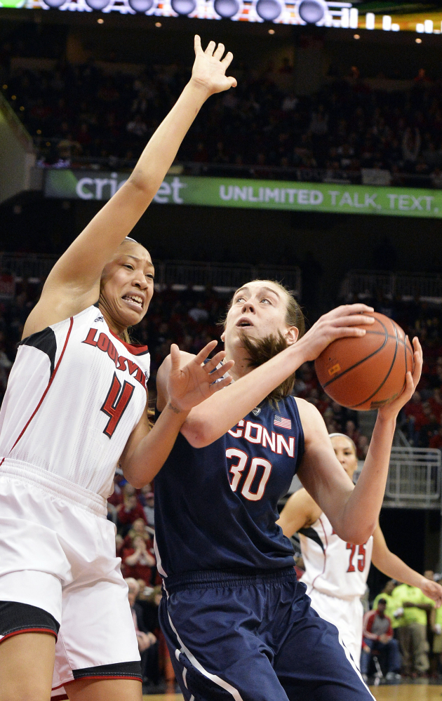 Connecticut’s Breanna Stewart, right, looks to score against Louisville’s Antonita Slaughter during the Huskies’ 68-48 win Monday at Louisville, Ky.