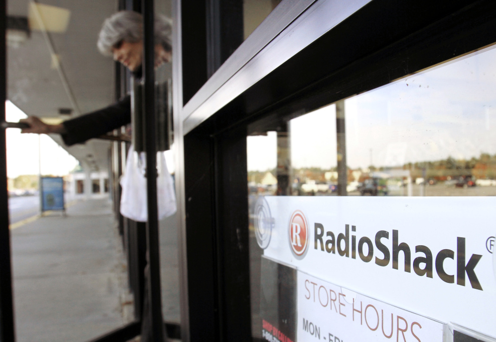 A shopper leaves a RadioShack store in Brunswick. The electronics retailer on Tuesday said it plans to close up to 1,100 of its underperforming stores in the U.S.