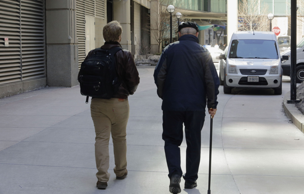First-year Northwestern University medical student Jared Worthington walks with his “Alzheimer’s buddy,” retired physician Dan Winship in Chicago’s Streeterville neighborhood.