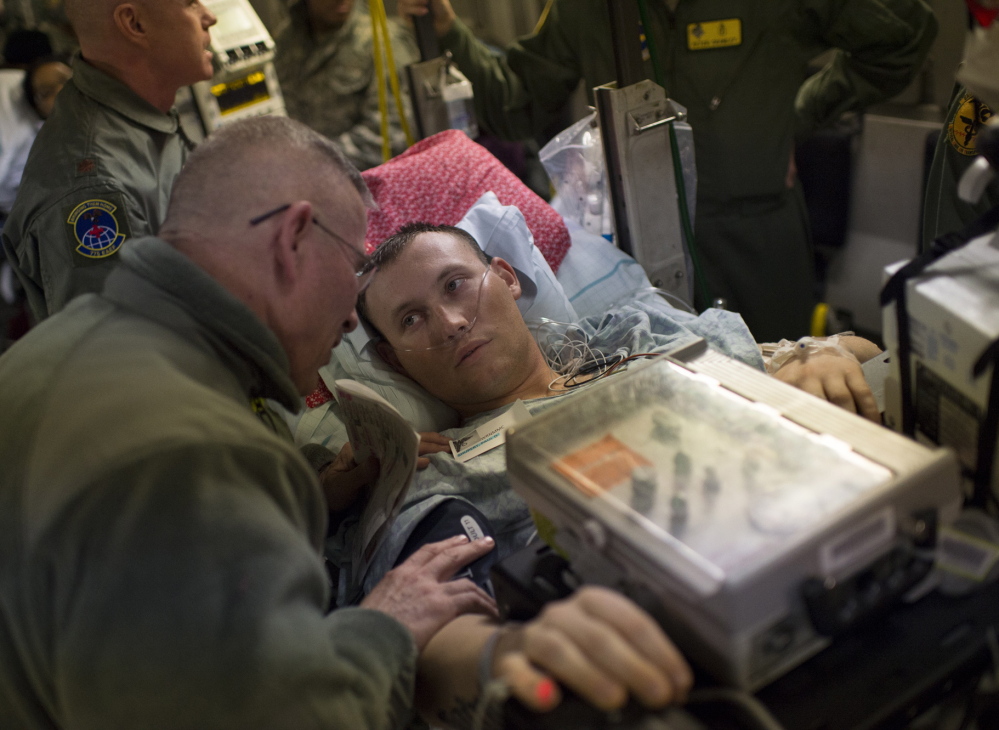Marine Lance Cpl. Paul Shupert, 22, waits to be carried off the C-17 after its arrival at Andrews Air Force Base in Maryland. He lost part of a leg after stepping on a land mine in Afghanistan’s Helmand province in November.