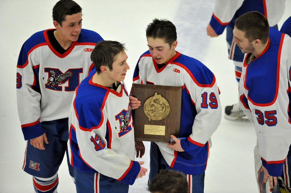 Jared Cunningham, 19, holds the championship plaque afrer Messalonskee earned its third straight Eastern Class B boys’ hockey title with a 9-3 win Tuesday over Presque Isle at Alfond Arena in Orono.