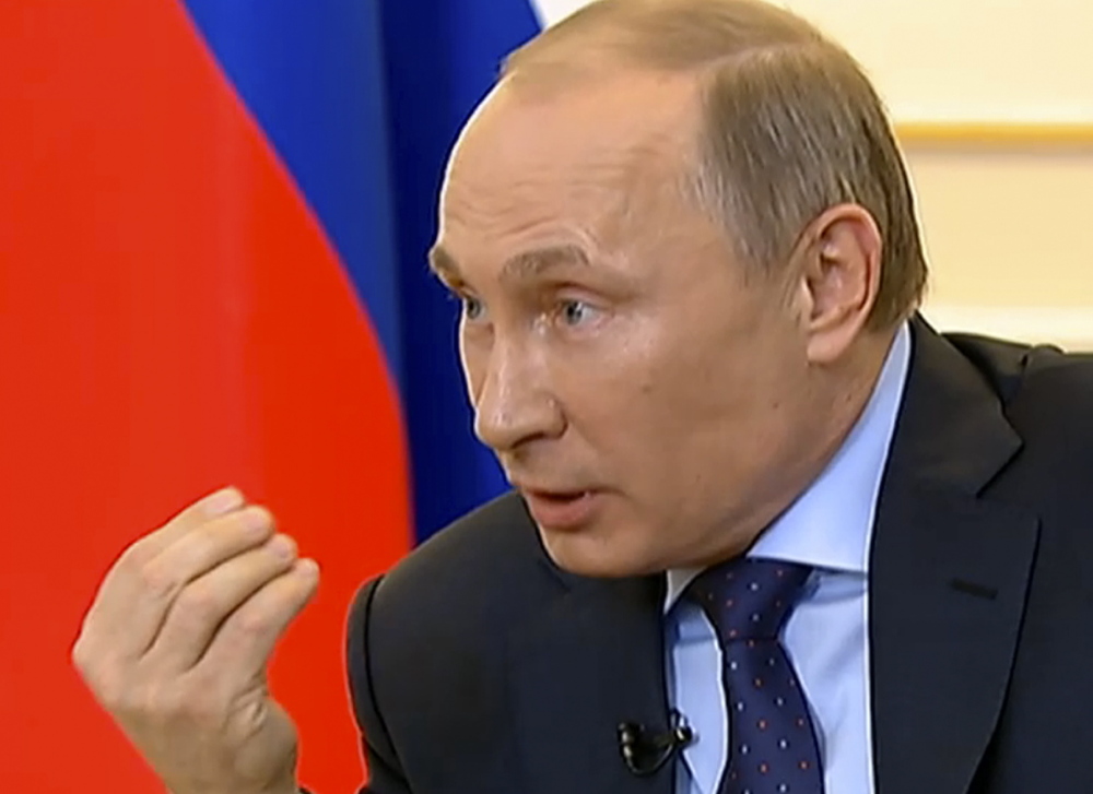 President Vladimir Putin answers journalists’ questions on Ukraine on Russian television Tuesday.