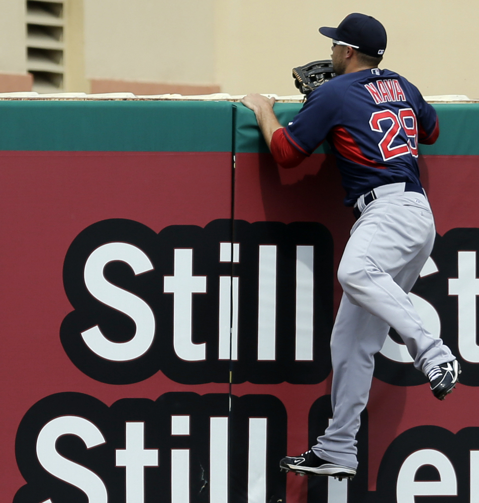 Boston left fielder Daniel Nava climbs the outfield wall in a vain attempt to snag Xavier Scruggs’ two-run blast during Wednesday’s exhibition loss to St. Louis.