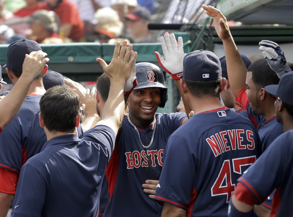 Xander Bogaerts of the Boston Red Sox is welcomed by teammates after hitting a two-run homer Wednesday in the sixth inning of an 8-6 loss to the St. Louis Cardinals in a spring-training game at Jupiter, Fla.