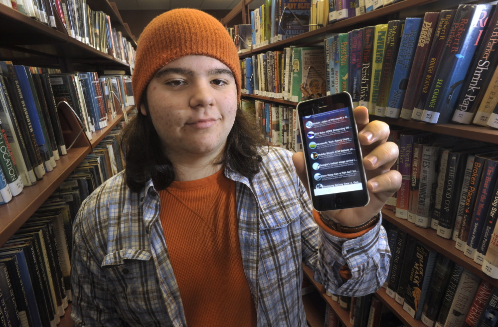 Julian Wyzykowski of Cape Elizabeth displays W8, a free Apple app for iPhone and iPod Touch devices that serves as a single source for news articles in various topic categories.