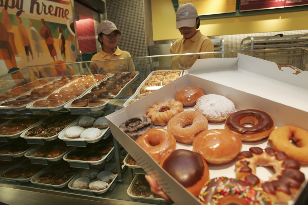 Doughnuts displayed at the Krispy Kreme store in Tokyo. The World Health Organization’s revised guidelines say sugar should be just 5 percent of daily total calories.