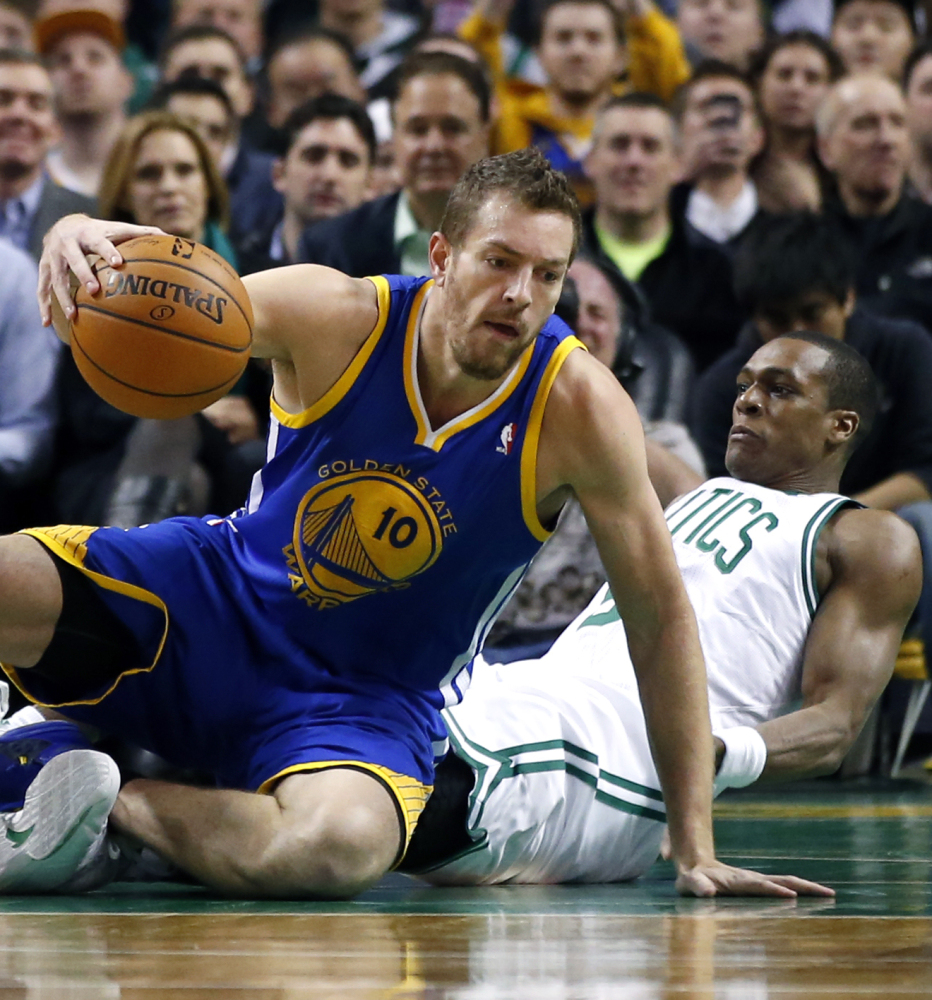 David Lee of the Golden State Warriors controls the ball while colliding with Rajon Rondo of the Boston Celtics during Golden State’s 108-88 victory Wednesday night.
