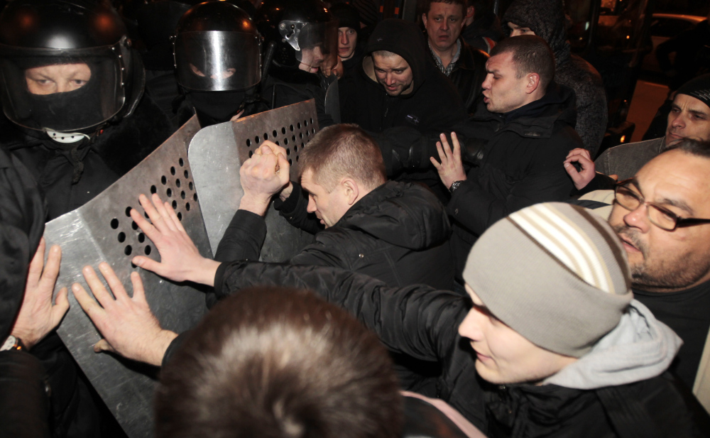 Ukrainian riot police officers block pro-Russian supporters of activist Pavel Gubarev during a rally in Donetsk, Ukraine, on Thursday.