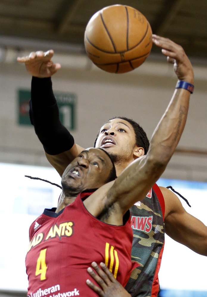 Maine’s Sherwood Brown, back, fights for a rebound against Fort Wayne’s Chris Porter during Thursday night’s game at the Portland Expo, won by the Mad Ants.