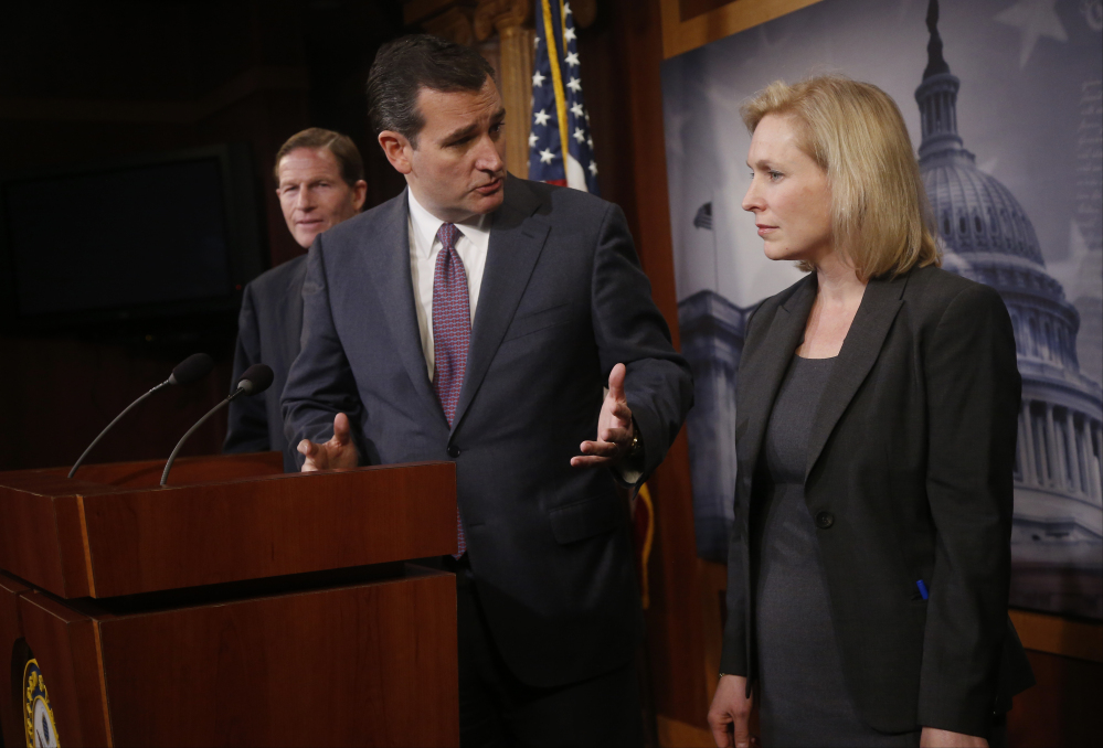 Sen. Ted Cruz, R-Texas, center, talks with Sen. Kirsten Gillibrand, D-N.Y., on Capitol Hill in Washington on Thursday during a news conference following a Senate vote on military sexual assaults.Cruz supported Gillibrand’s bill.