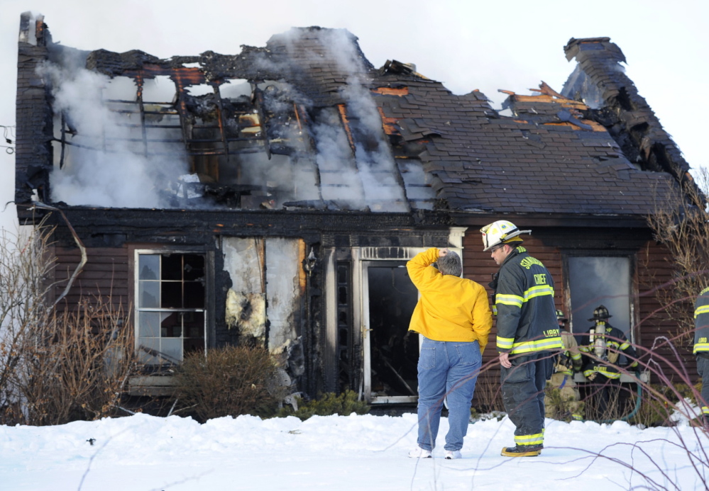 A cigarette tossed outside near the front door of this home in Standish touched off a fire that destroyed the house Friday. Fire Chief Brent Libby, seen talking with homeowner Denise Dyer, said the fire at 1055 Chadbourne Road – Route 35 – was reported by a passerby shortly after 3 p.m. When firefighters arrived, the fire had spread through the house and out the roof, Libby said. No one was injured in the blaze.
