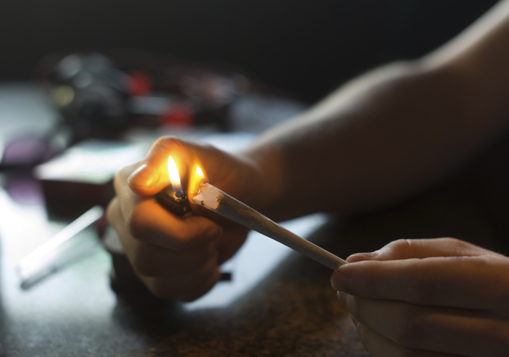 A visitor lights a marijuana joint in coffee shop Mississippi in Maastricht, southern Netherlands.