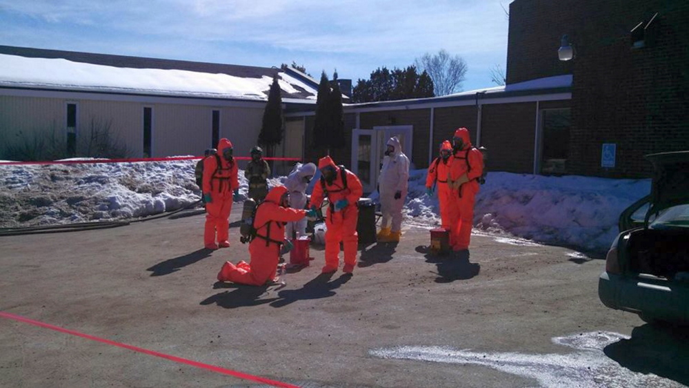 Maine Drug Enforcement Agency officers in protective suits collect evidence in a meth-lab case Friday at the Waterville Fireside Inn & Suites.