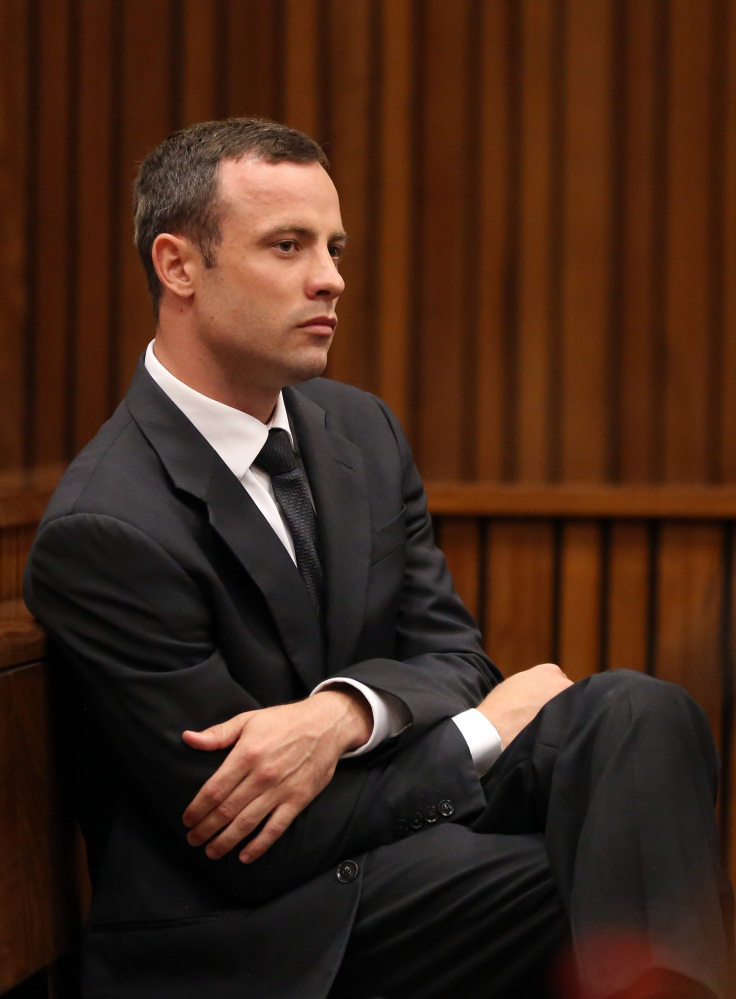 Oscar Pistorius sits in the dock during his trial at the high court in Pretoria, South Africa, on Friday. He is charged with murder for the shooting death of his girlfriend, Reeva Steenkamp, on Valentines Day in 2013.