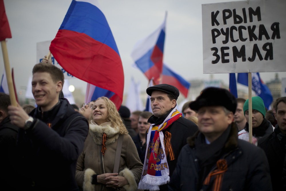 Pro-Putin demonstrators hold Russian national flags and posters reading “Crimea is Russia!” as they gather in Moscow’s Red Square on Friday. Leaders of both houses of parliament said they would support a vote by Crimeans to split with Ukraine and join Russia – signaling for the first time that the Kremlin was prepared to annex the strategic region.