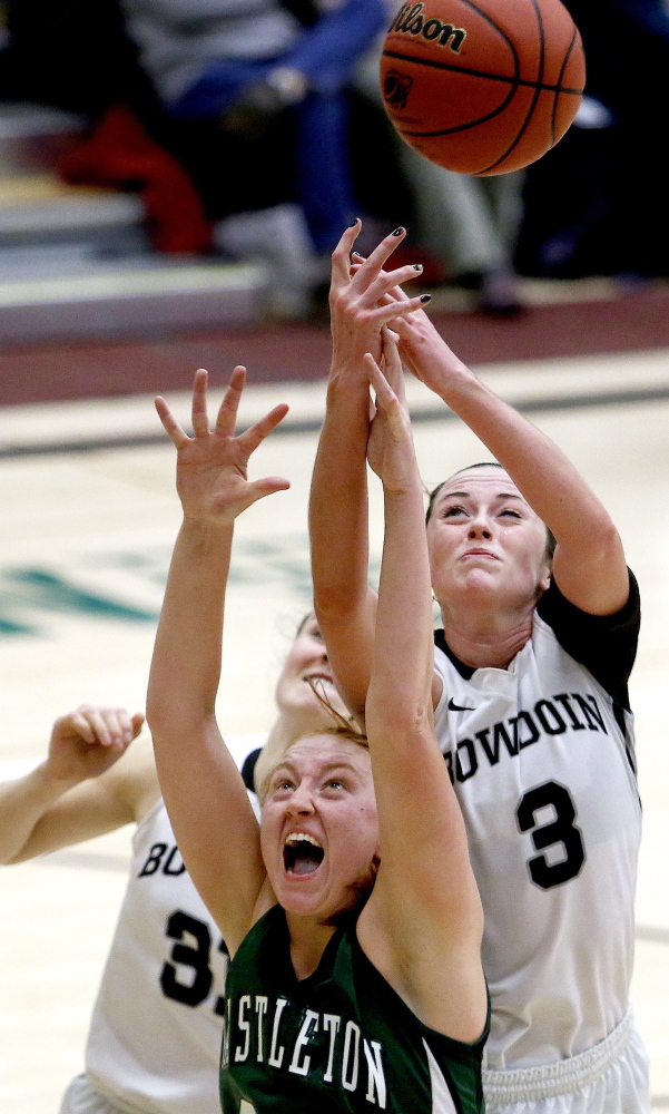 Shannon Brady, right, of Bowdoin attempts to come up with a rebound over Meghan O’Sullivan of Castleton State during their first-round game of the NCAA tournament Friday night.