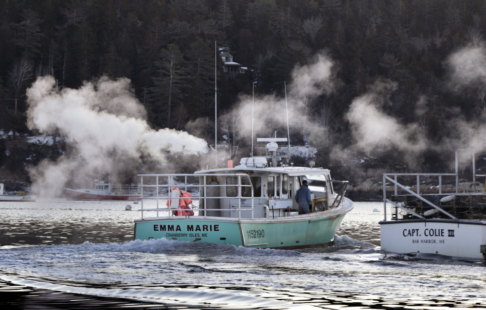 Boat exhaust rises as lobsterman Mark Fernald heads out from Northeast Harbor on Friday morning. The official beginning of spring is less than two weeks away, but temperatures still remain in the low teens at dawn.