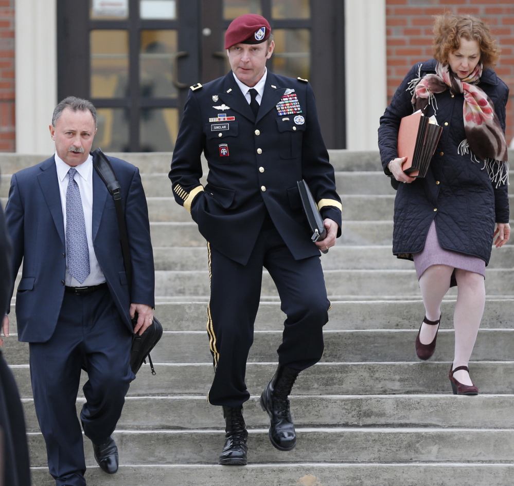 Army Brig. Gen. Jeffrey Sinclair leaves the courthouse with attorneys Richard Scheff, left, and Ellen Brotman at Fort Bragg in Fayetteville, N.C., on Tuesday.