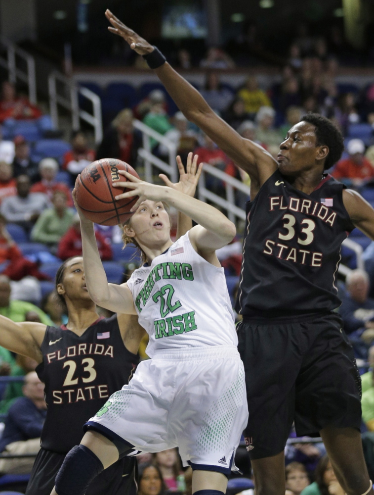 Notre Dame’s Madison Cable is pressured by Florida State’s Natasha Howard, 33, and Ivey Slaughter, 23, during Friday’s ACC tourney game, won by the Irish.