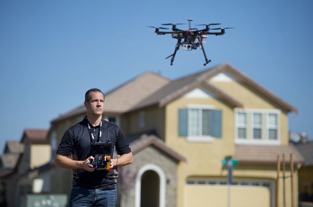 Christopher Brown of Next New Homes Group uses a multi-rotor drone to take aerial video of a house in Sacramento, Calif. He calls the drones a “game-changer” for marketing homes.