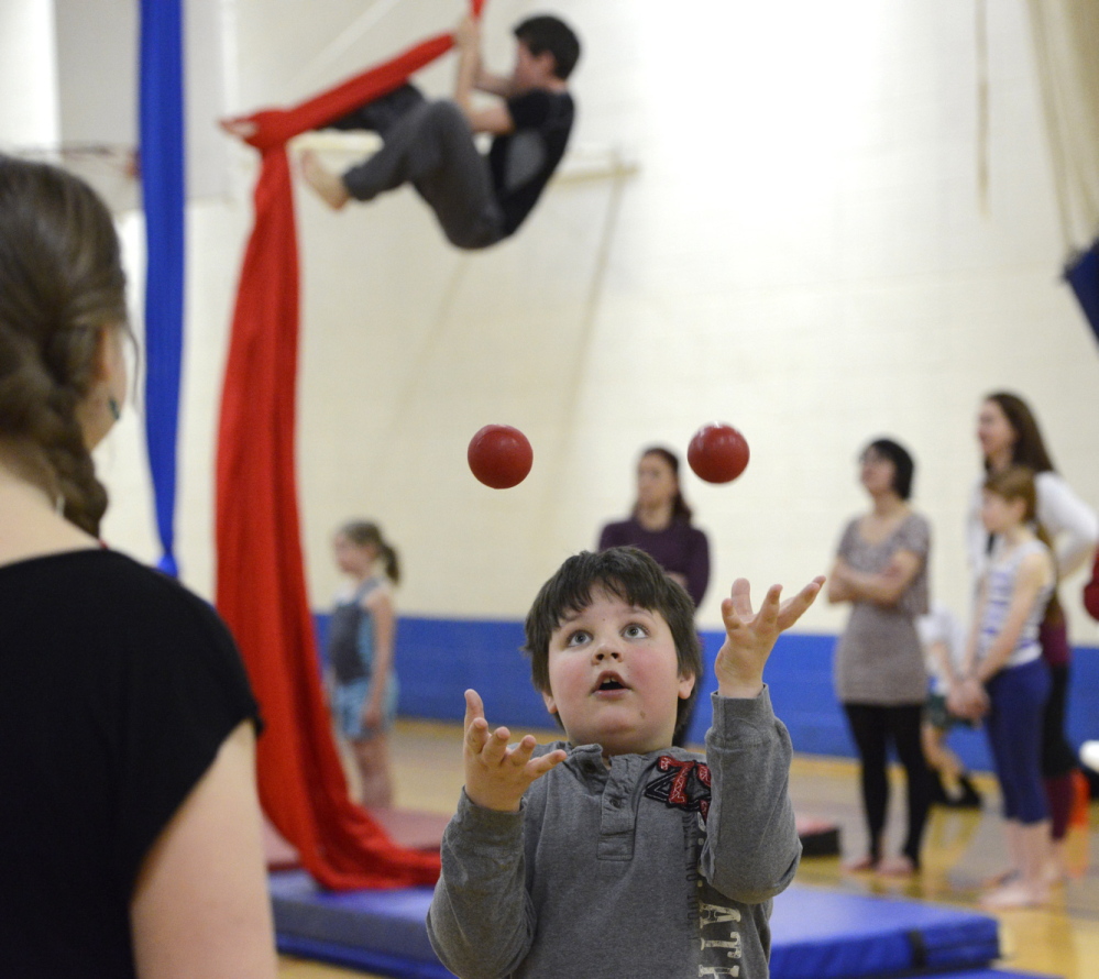 Martha Fournier shows Kyle Brown, 8, of Gorham how to juggle. Above left, Kyle gets the hang of it.