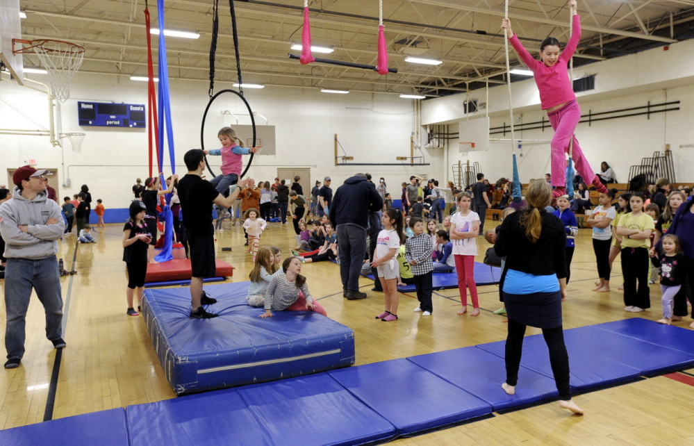 John Patriquin/Staff Photographer Kids are lined up to participate during Circus Atlantic’s open house at Reiche Community School in Portland on Saturday.