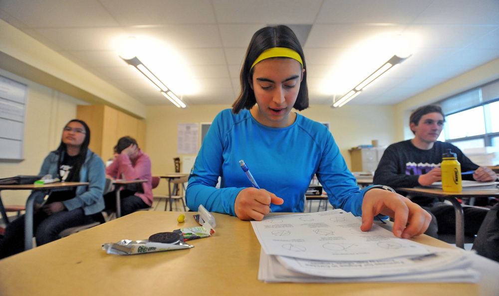 Ursula Hebert-Johnson, 17, a senior at Waterville Senior High School, works on a math equation Wednesday, March 5, 2014 during math team practice.