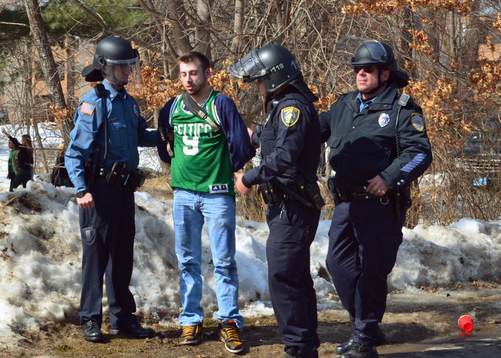 Police detain a participant in the pre-St. Patrick's Day "Blarney Blowout" near the University of Massachusetts in Amherst, Mass. on Saturday. Amherst police said early Sunday that 73 people had been arrested after authorities spent most of the day Saturday attempting to disperse several large gatherings around the campus for the party traditionally held the Saturday before spring break.